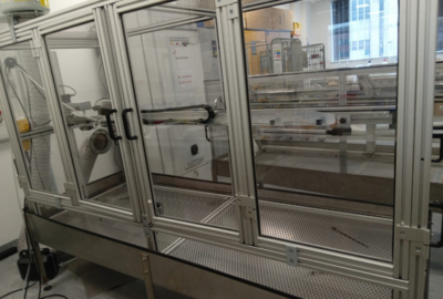 Large, floor to ceiling container with three large clear doors.